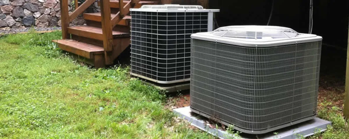 Heat pump installation and service units outside a home in Wellesley, MA